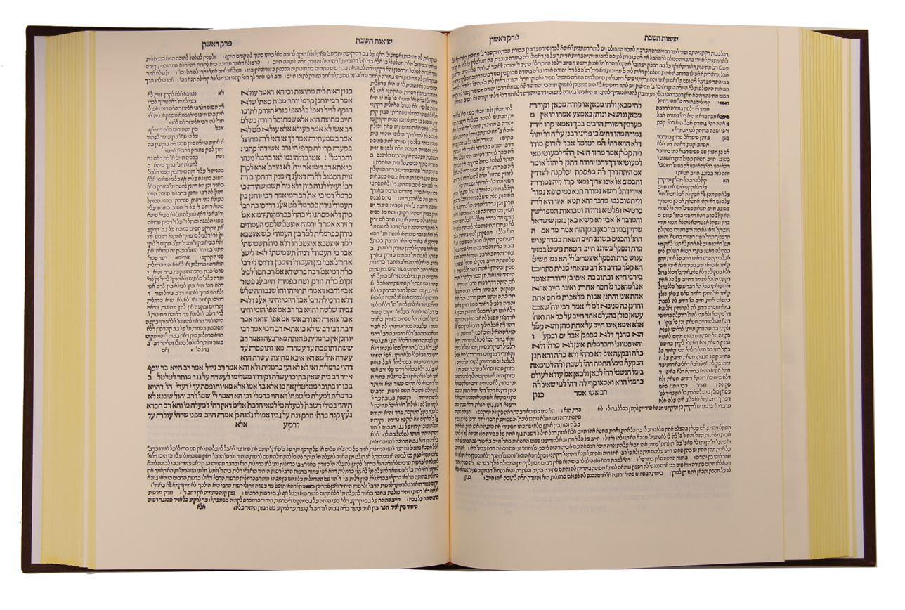 An open page of the Bomberg Venice Talmud, the central text framed on every side by columns of commentary in different typefaces.