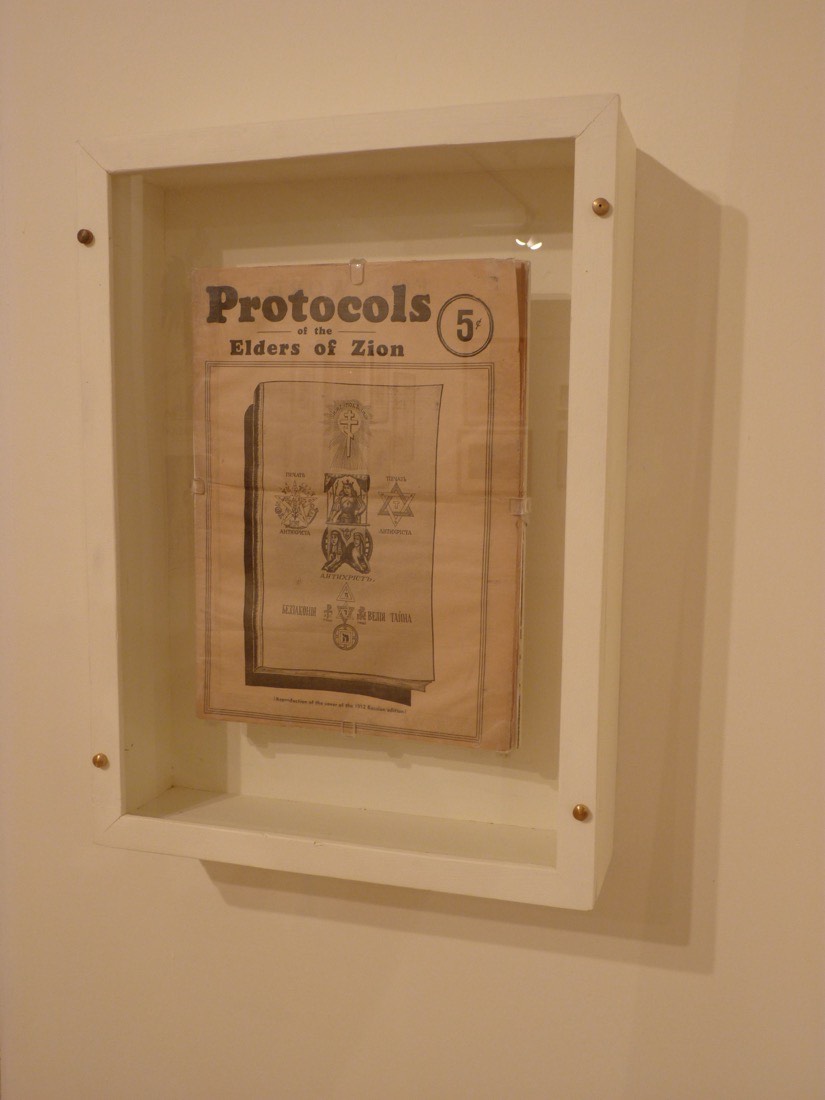 A printed edition of the Protocols of the Elders of Zion, its cover marked with a Star of David, photographed in a collection of antisemitic objects in Jerusalem.
