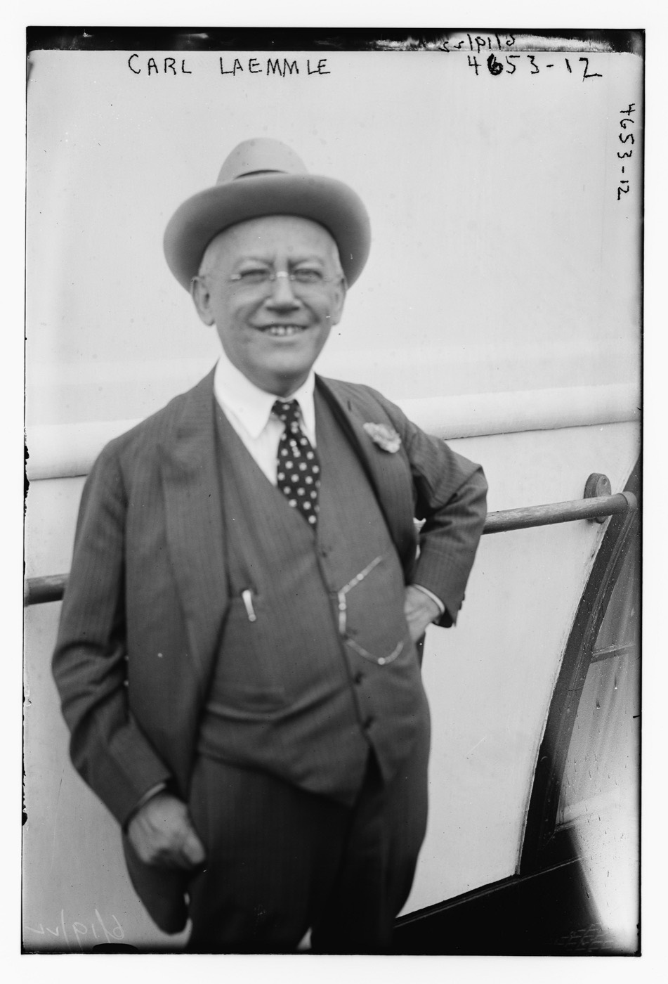 A formal 1918 portrait photograph of Carl Laemmle, founder of Universal Pictures, in a suit, seated.