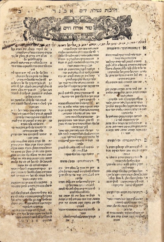 A worn, aged page from an early printed edition of the Shulchan Aruch, dense columns of Hebrew text under a decorated header reading Tur Orach Chayim.